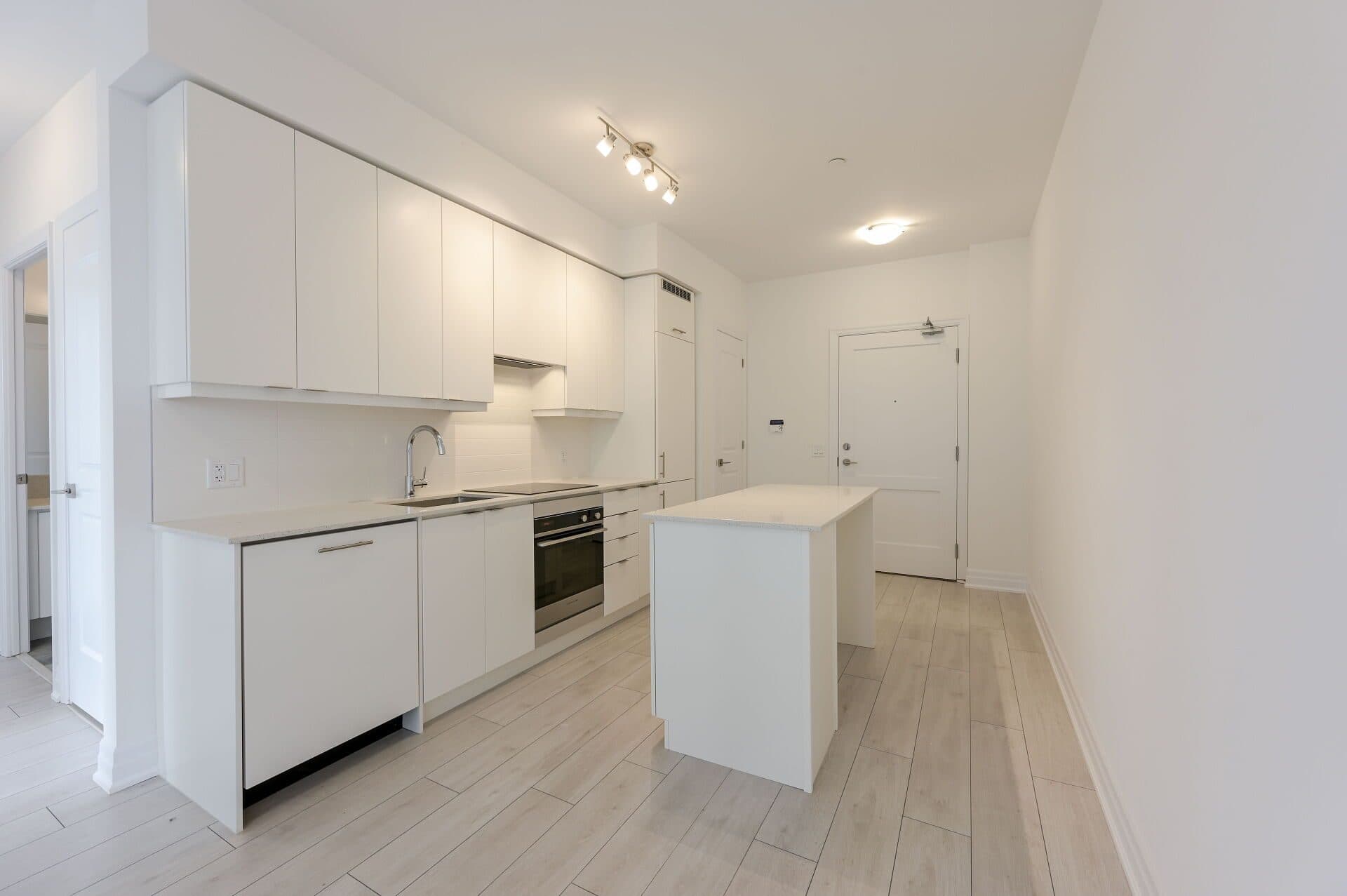 Modern Kitchen with Island and White Cabinets at Rental Listing in Mississauga, a 2 bedroom rental in 30 Elm Drive West, Mississauga, ON, listed for $2,500 per month