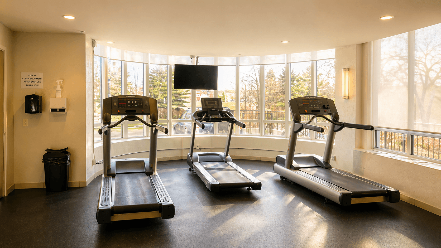 Fitness Area with Treadmills and Natural Light at 1-Bedroom Condo in Prime Richmond Hill Location, a 1 bedroom rental in 39 Oneida Crescent, Richmond Hill, ON, listed for $2,075 per month