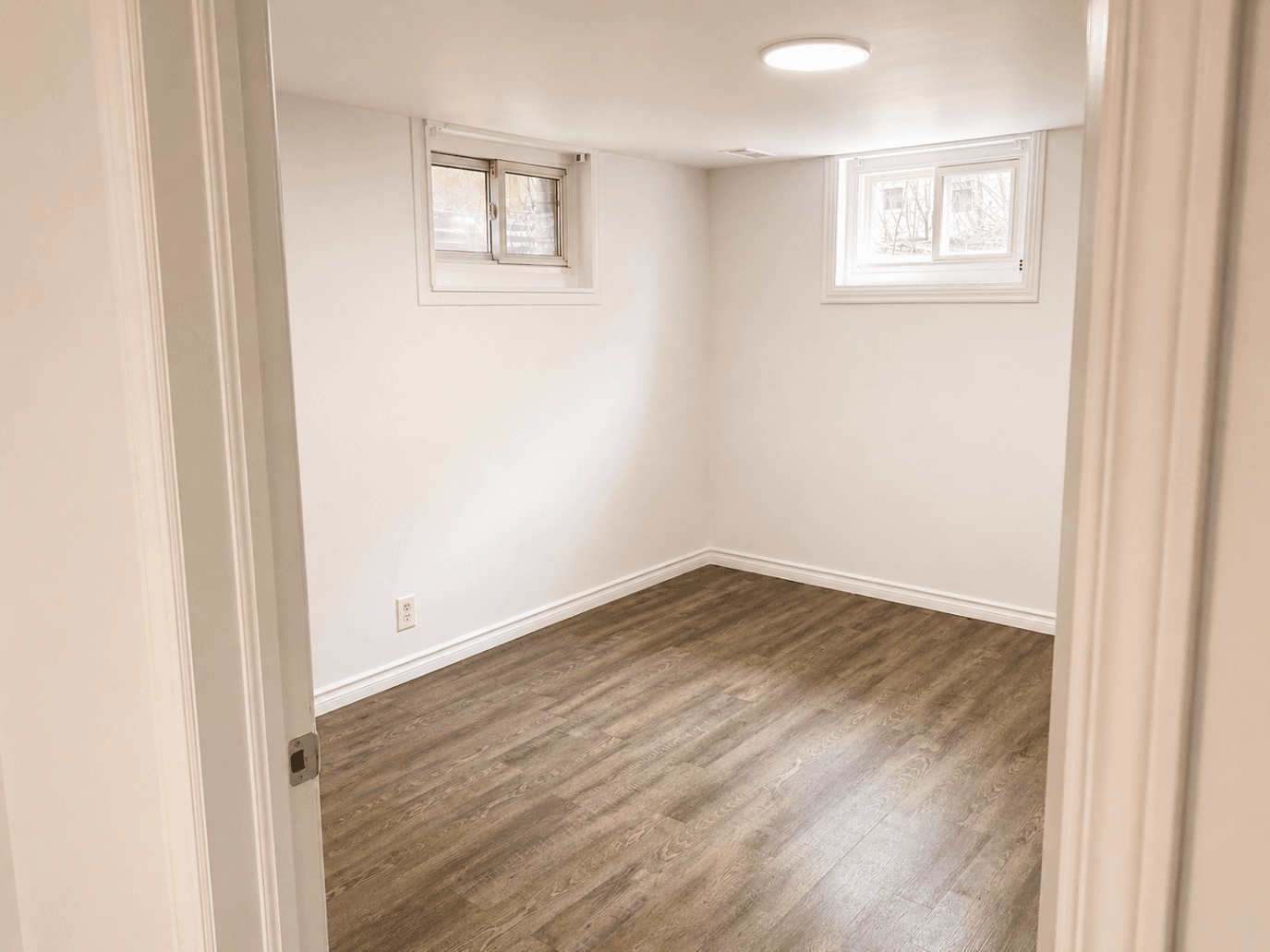 Small Bedroom with Windows at Modern 2-Bedroom Condo (Lower Level) in Hintonburg – Parking Included, a 2 bedroom rental in 210 Armstrong Street, Ottawa, ON, listed for $1,850 per month