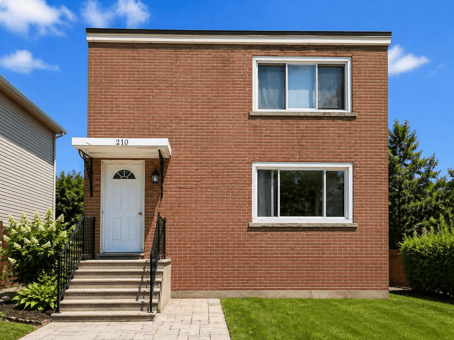 Front View of Brick House at Modern 2-Bedroom Condo (Lower Level) in Hintonburg – Parking Included, a 2 bedroom rental in 210 Armstrong Street, Ottawa, ON, listed for $1,850 per month