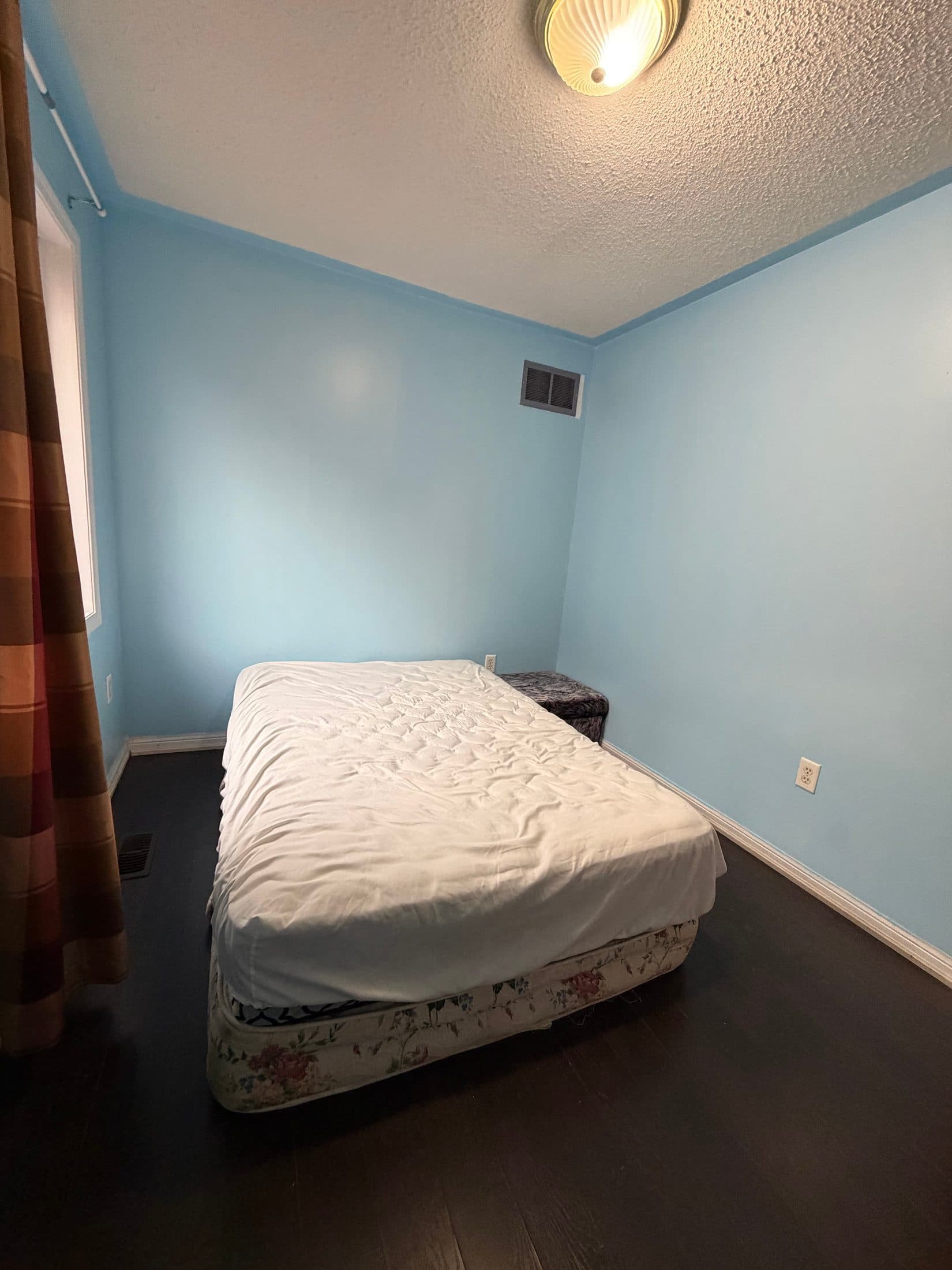 Cozy Primary Bedroom with Blue Walls at Spacious 4 Bedroom Detached Home for Rent in Brampton – 85 Herdwick Street, a 4 bedroom rental in 85 Herdwick Street, Brampton, ON, listed for $3,250 per month