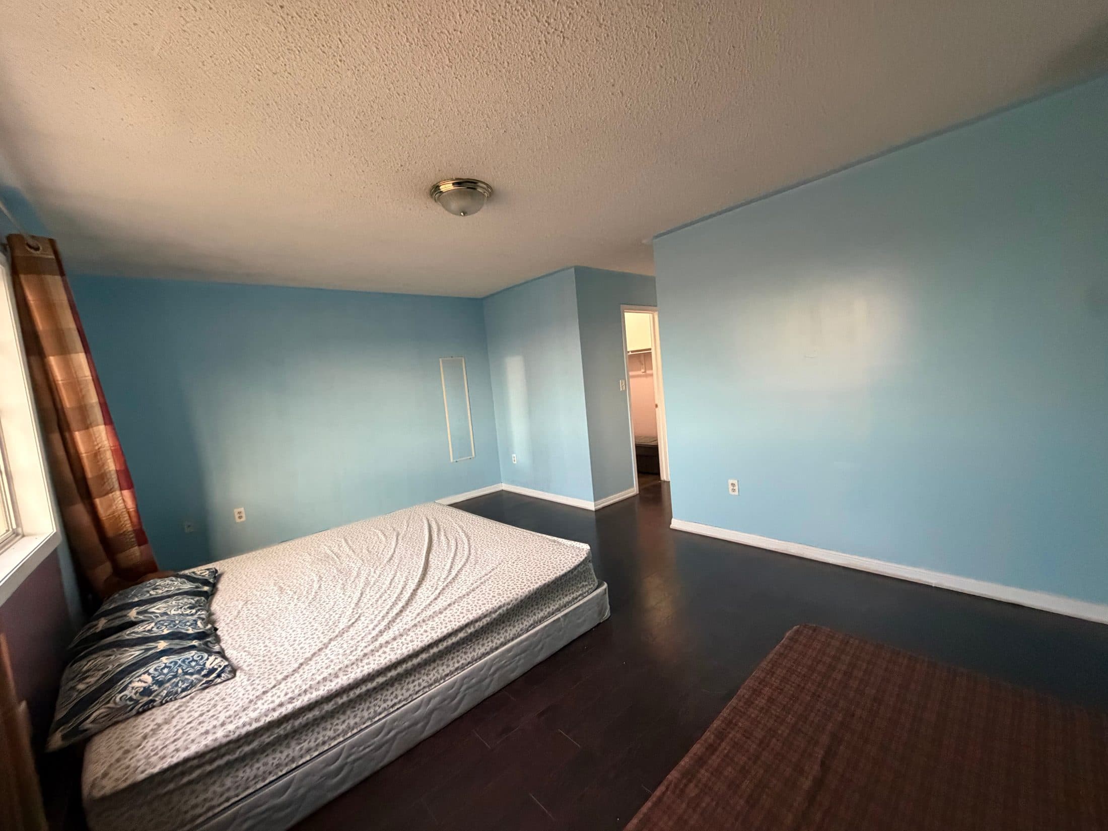 Spacious Primary Bedroom with Blue Walls at Spacious 4 Bedroom Detached Home for Rent in Brampton – 85 Herdwick Street, a 4 bedroom rental in 85 Herdwick Street, Brampton, ON, listed for $3,250 per month