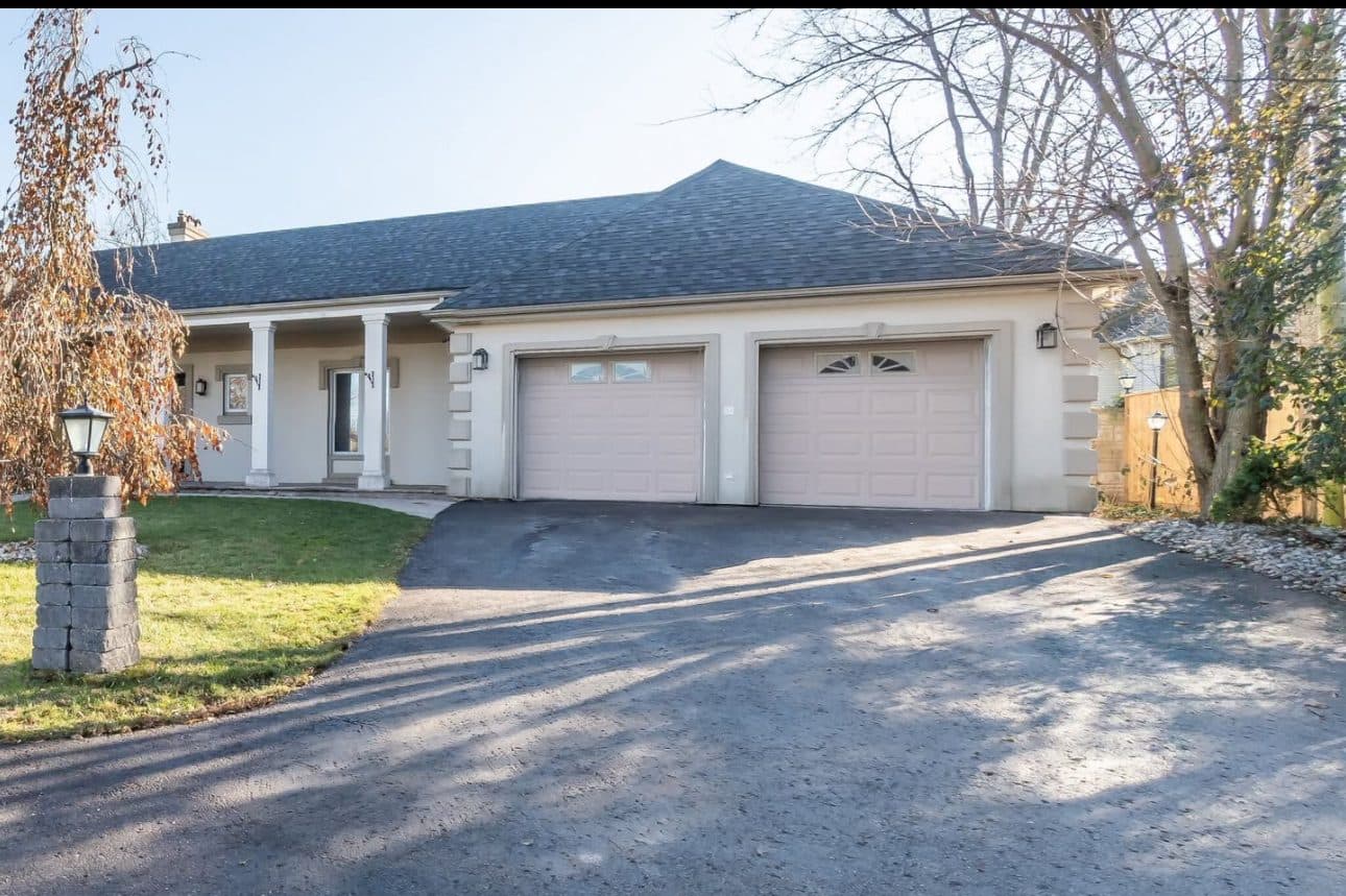 Front View of the House with Driveway at Spacious 3-Bedroom Bungalow for Rent – 137 Commissioners Rd, London, a 3 bedroom rental in 137 Commissioners Road East, London, ON, listed for $3,400 per month