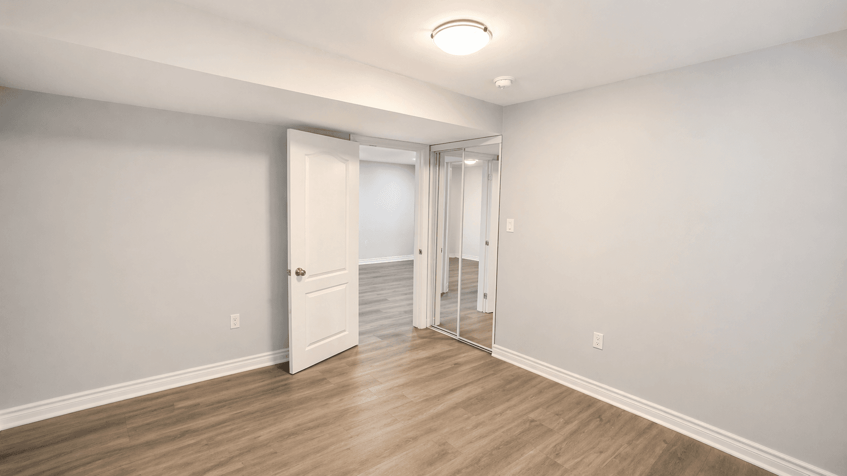 Secondary Bedroom with Mirrored Closet at Spacious 2-Bedroom Basement Unit for Rent – 117 Hibbard Dr, Ajax, a 2 bedroom rental in 117 Hibbard Drive, Ajax, ON, listed for $1,900 per month