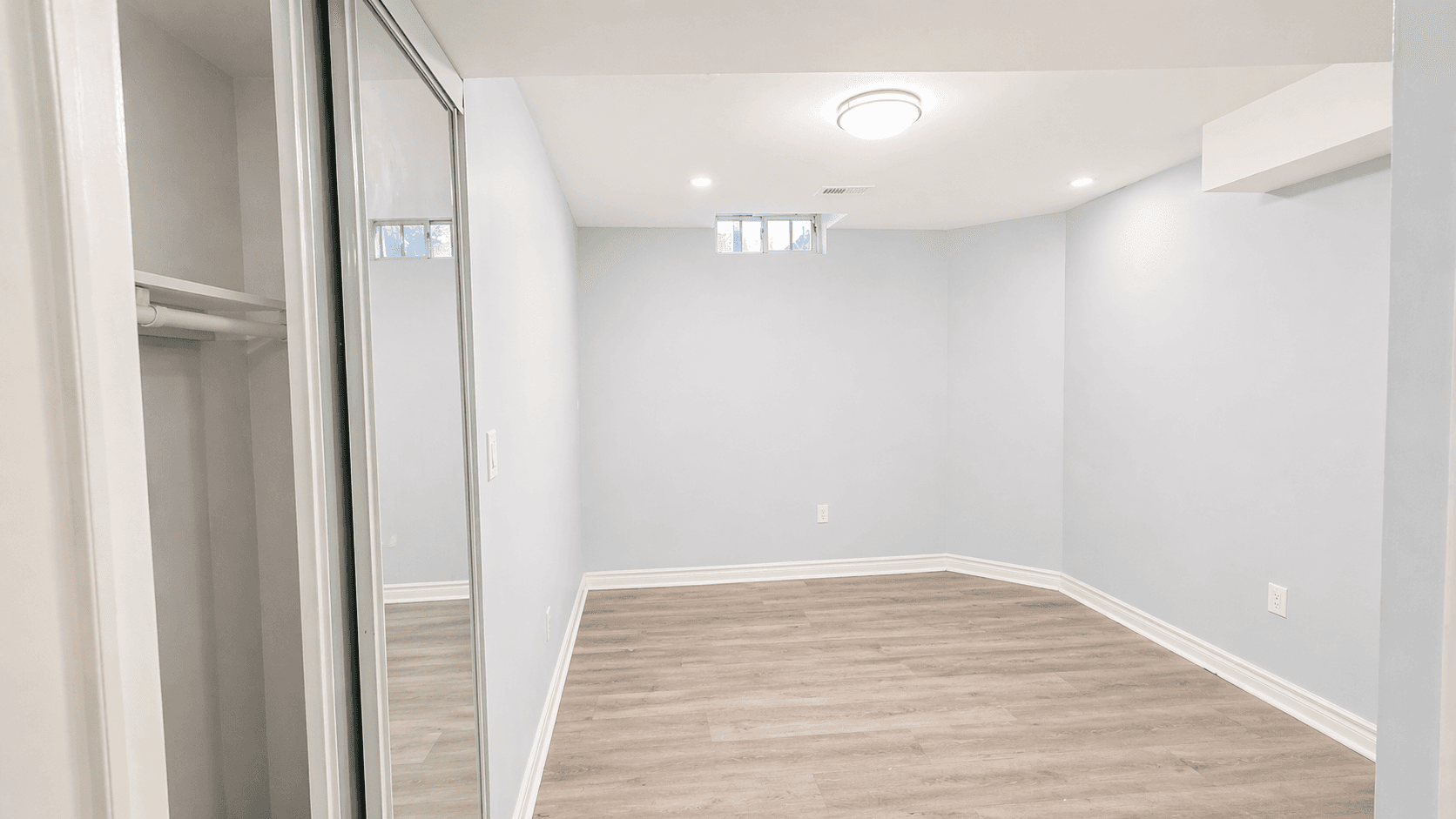 Cozy Bedroom with Light Blue Walls at Spacious 2-Bedroom Basement Unit for Rent – 117 Hibbard Dr, Ajax, a 2 bedroom rental in 117 Hibbard Drive, Ajax, ON, listed for $1,900 per month