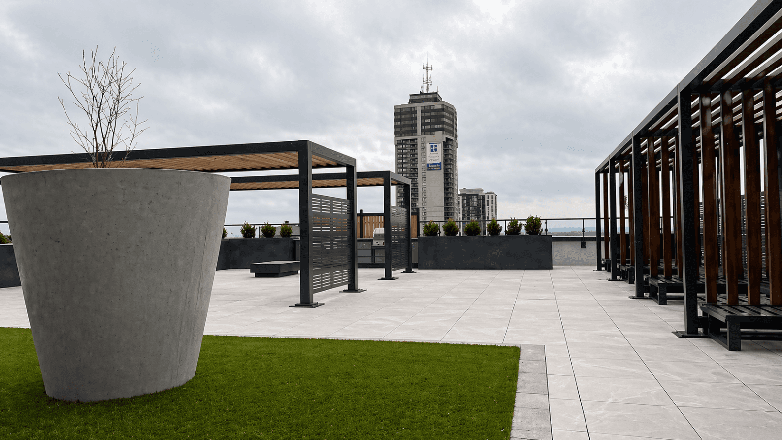 Rooftop Terrace with Seating and Greenery at Brand New 1-Bedroom Condo in Prime Hamilton Location, a 1 bedroom rental in 75 James Street South, Hamilton, ON, listed for $1,850 per month