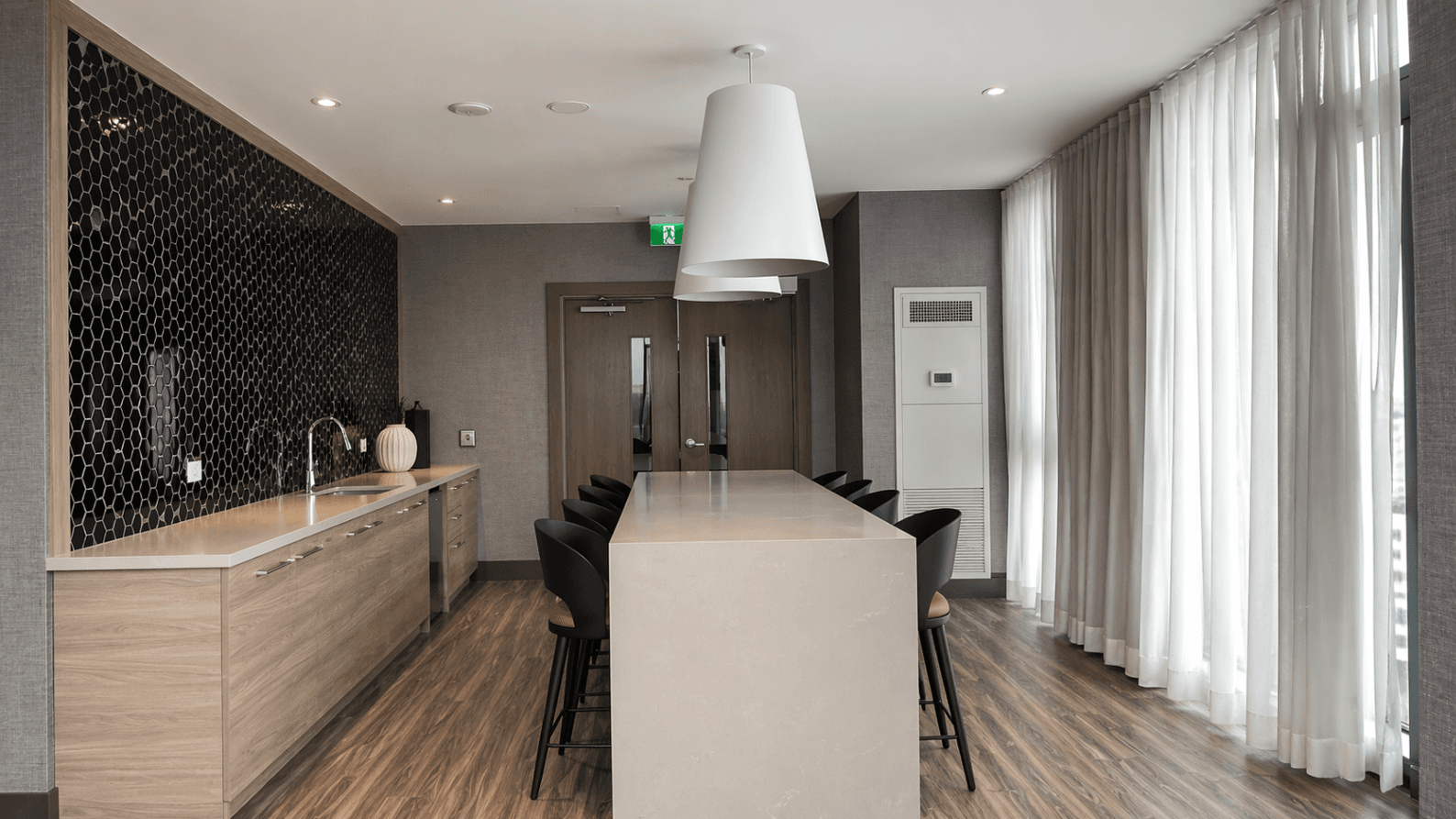 Modern Kitchen with Island Seating at Brand New 1-Bedroom Condo in Prime Hamilton Location, a 1 bedroom rental in 75 James Street South, Hamilton, ON, listed for $1,850 per month