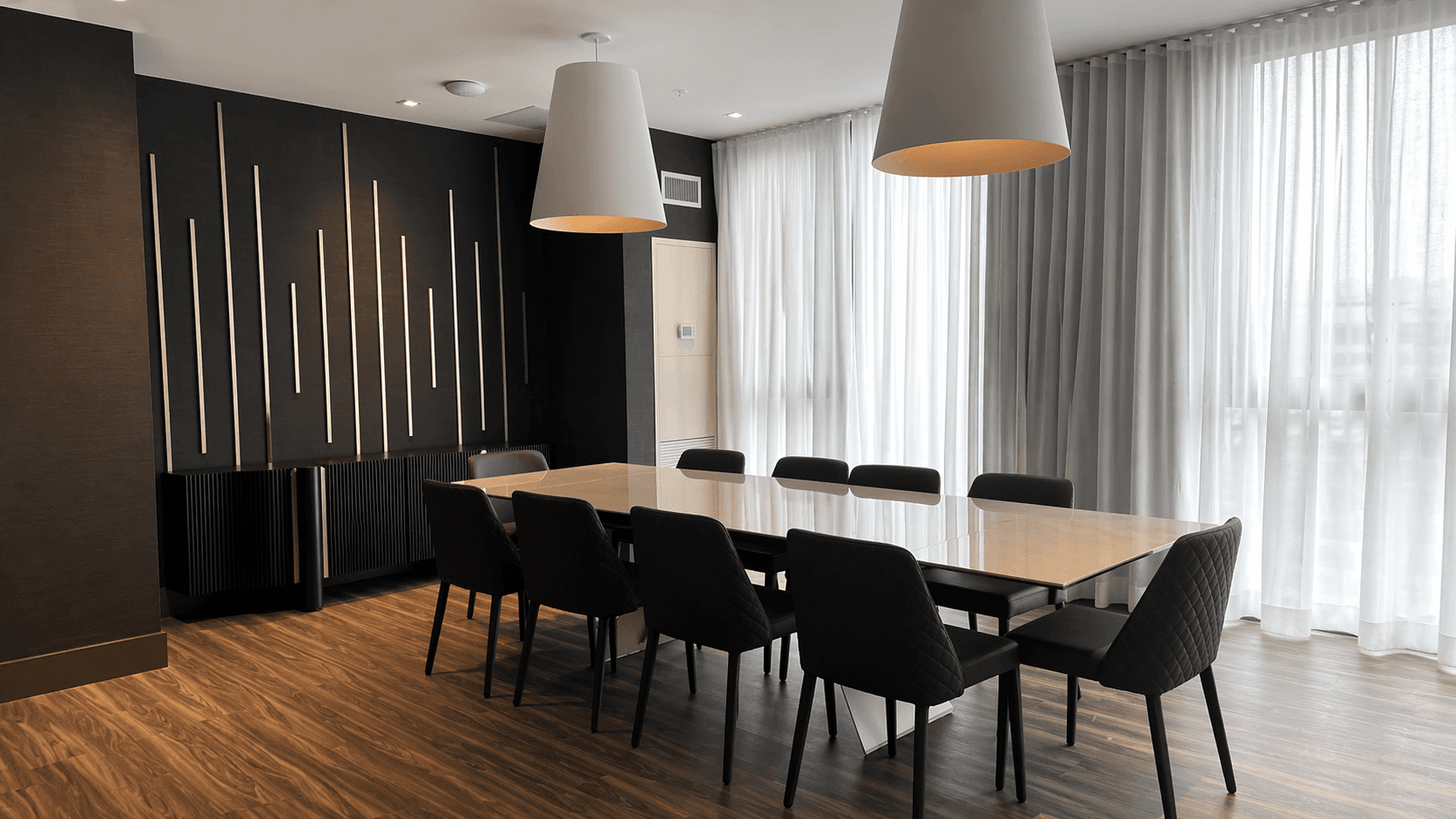 Modern Dining Area with Large Table at Brand New 1-Bedroom Condo in Prime Hamilton Location, a 1 bedroom rental in 75 James Street South, Hamilton, ON, listed for $1,850 per month