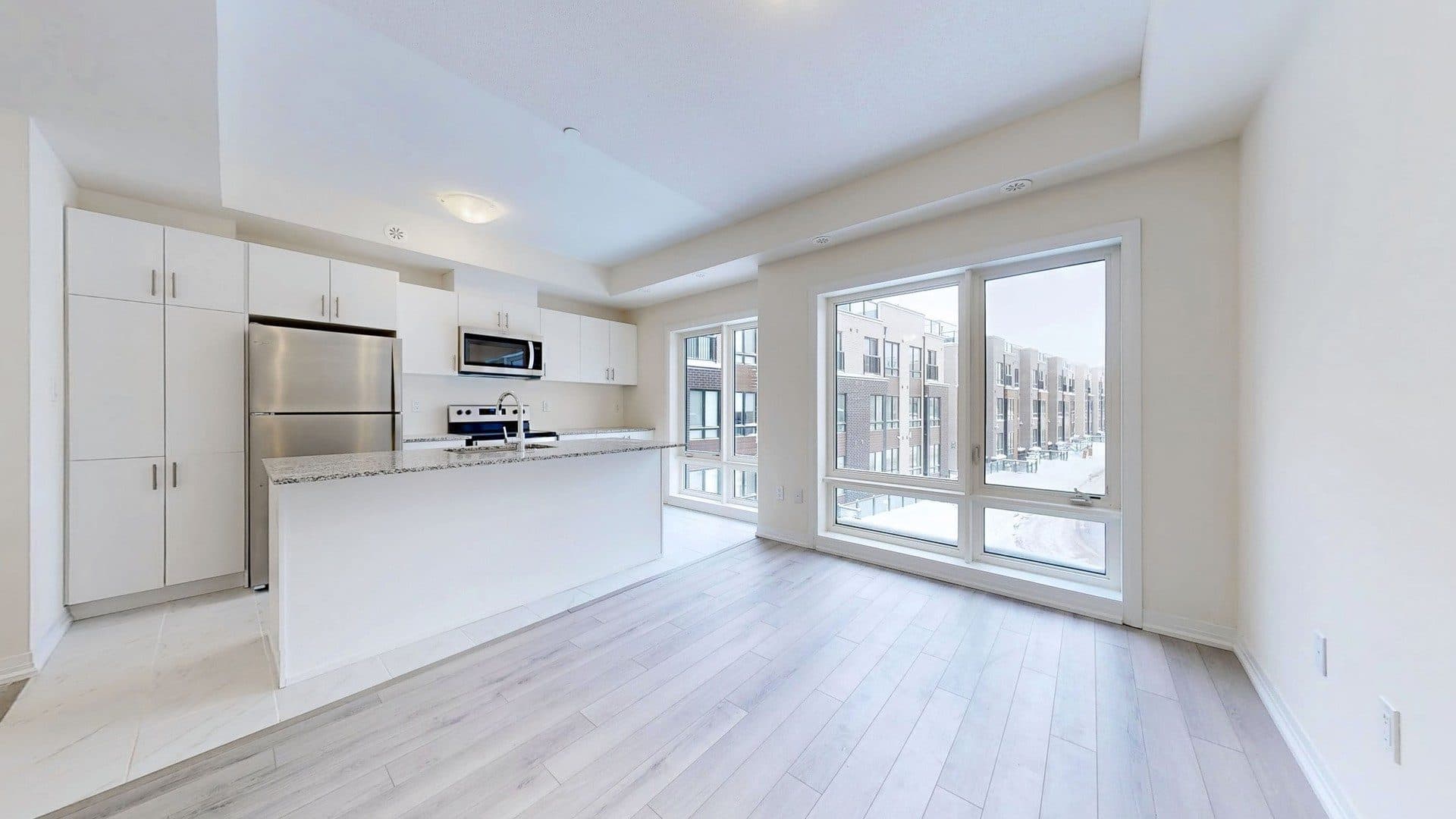 Modern Kitchen with Large Windows at Rental Listing in Scarborough, a 1 bedroom rental in 165 Tapscott Road, Scarborough, ON, listed for $1,000 per month