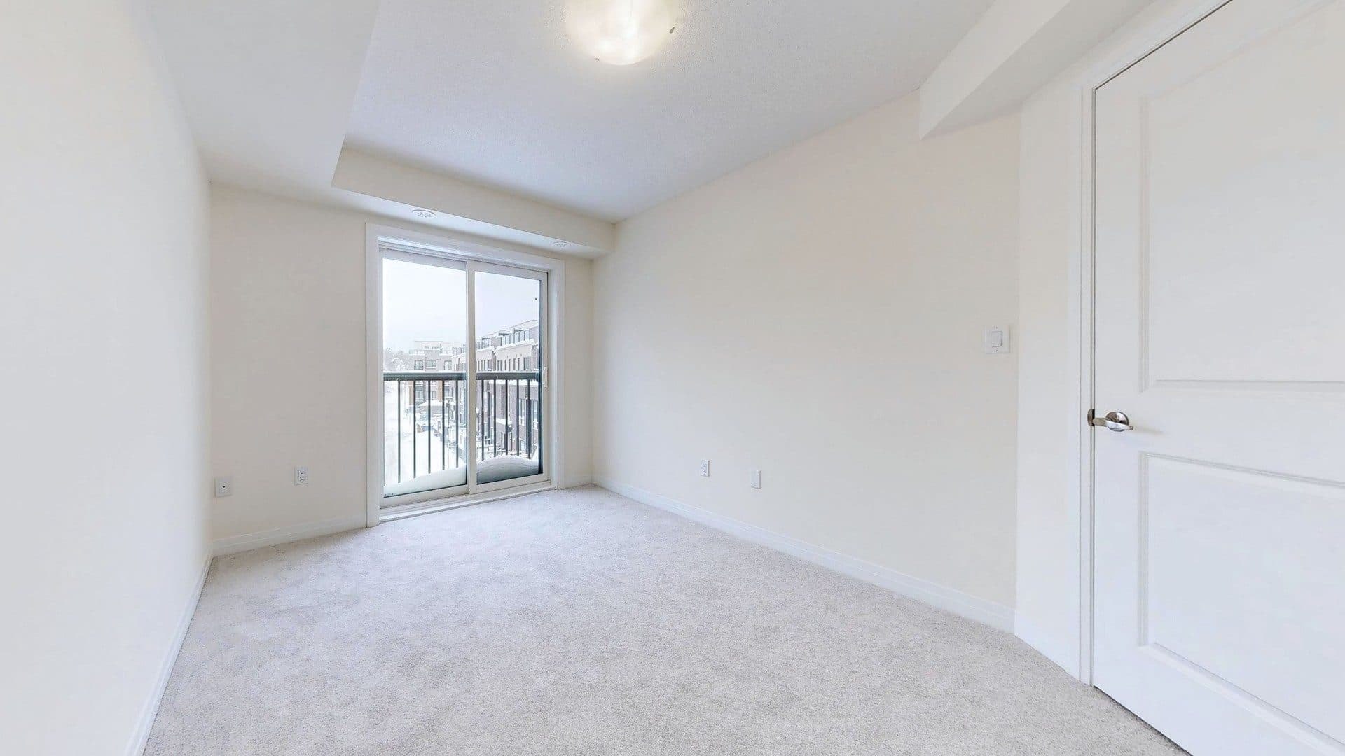 Bright Primary Bedroom with Balcony Access at Rental Listing in Scarborough, a 1 bedroom rental in 165 Tapscott Road, Scarborough, ON, listed for $1,000 per month