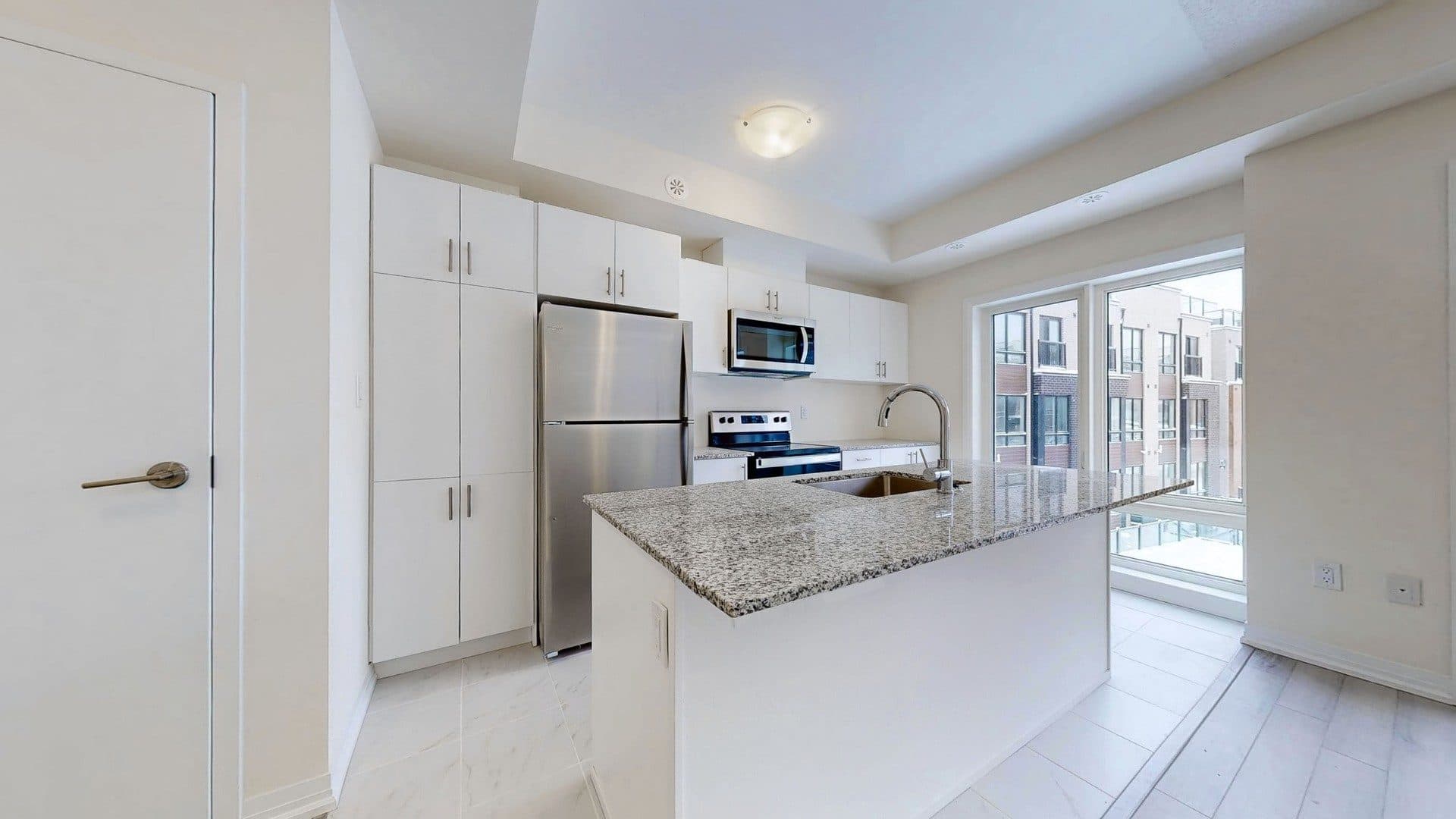 Modern Kitchen with Granite Countertops at Rental Listing in Scarborough, a 1 bedroom rental in 165 Tapscott Road, Scarborough, ON, listed for $1,000 per month