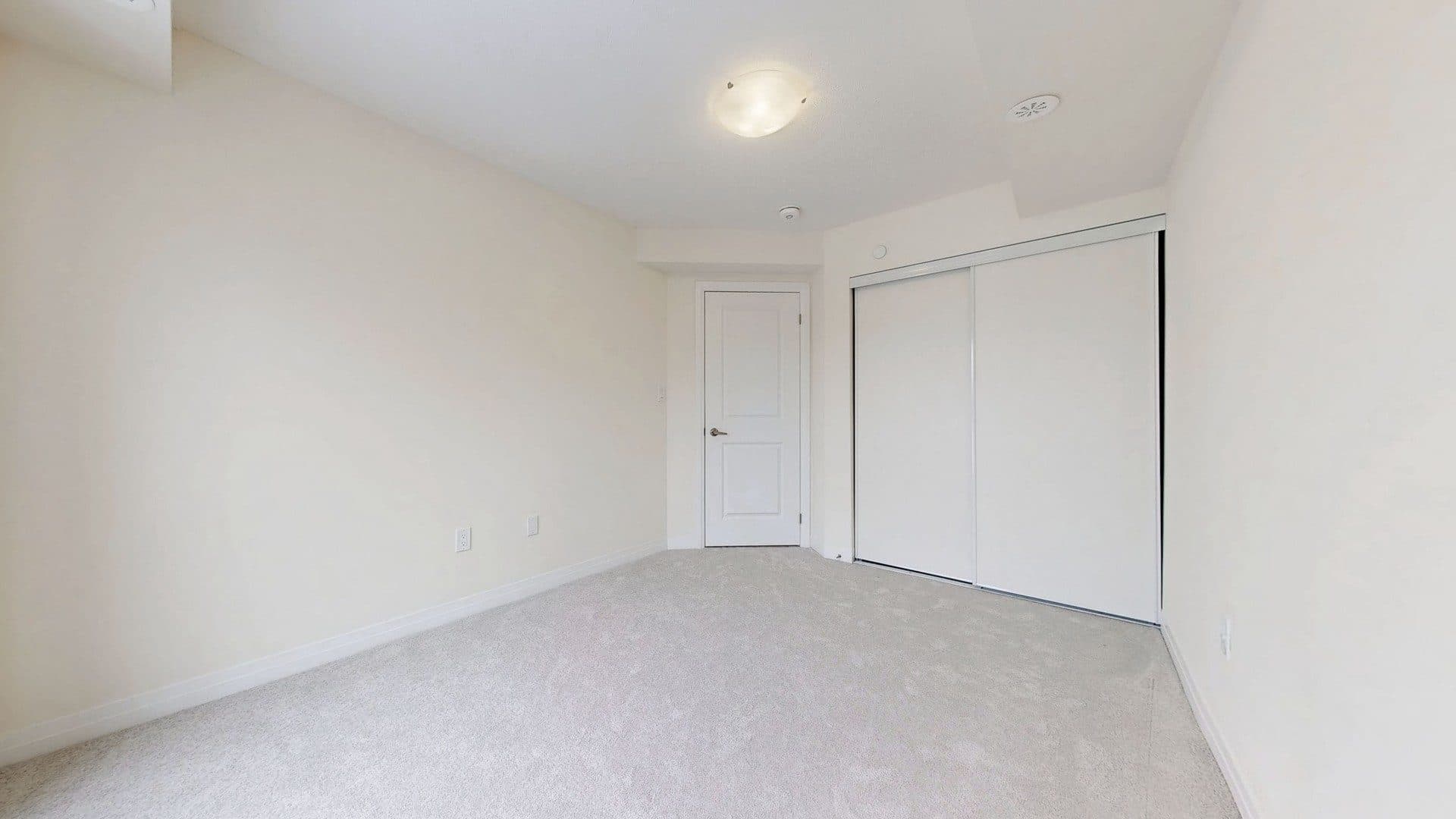 Cozy Guest Bedroom with Carpeted Floor at Rental Listing in Scarborough, a 1 bedroom rental in 165 Tapscott Road, Scarborough, ON, listed for $1,000 per month