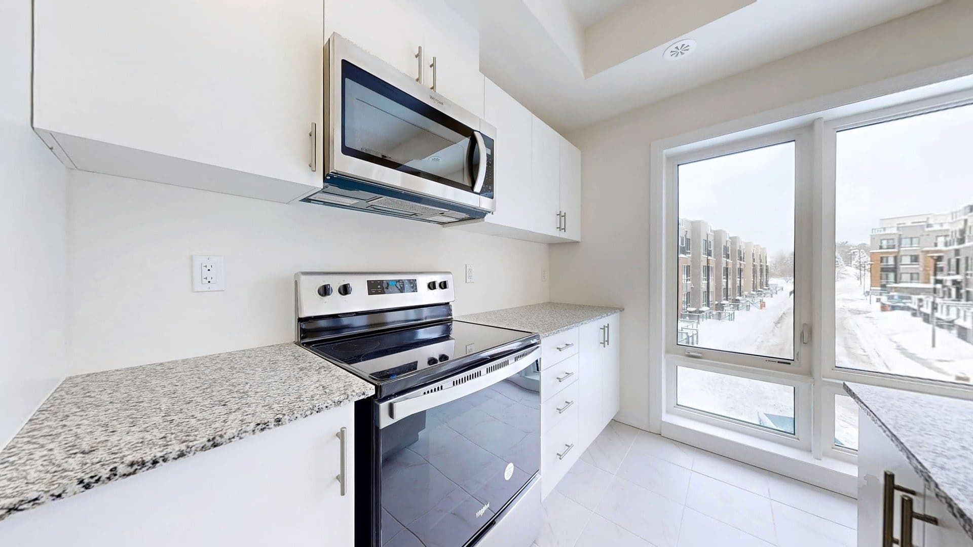 Modern Kitchen with Large Windows at Rental Listing in Scarborough, a 1 bedroom rental in 165 Tapscott Road, Scarborough, ON, listed for $1,000 per month