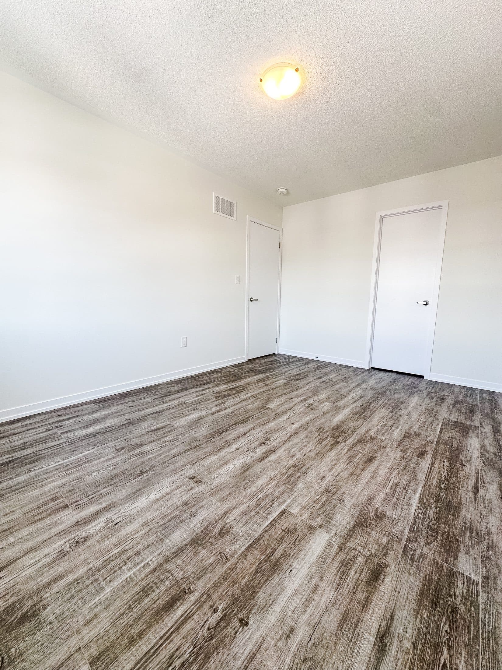 Spacious Primary Bedroom with New Flooring at 1 Bedroom Townhouse in Oshawa for $1,200, a 1 bedroom rental in 2004 Horace Duncan Crescent, Oshawa, ON, listed for $1,200 per month