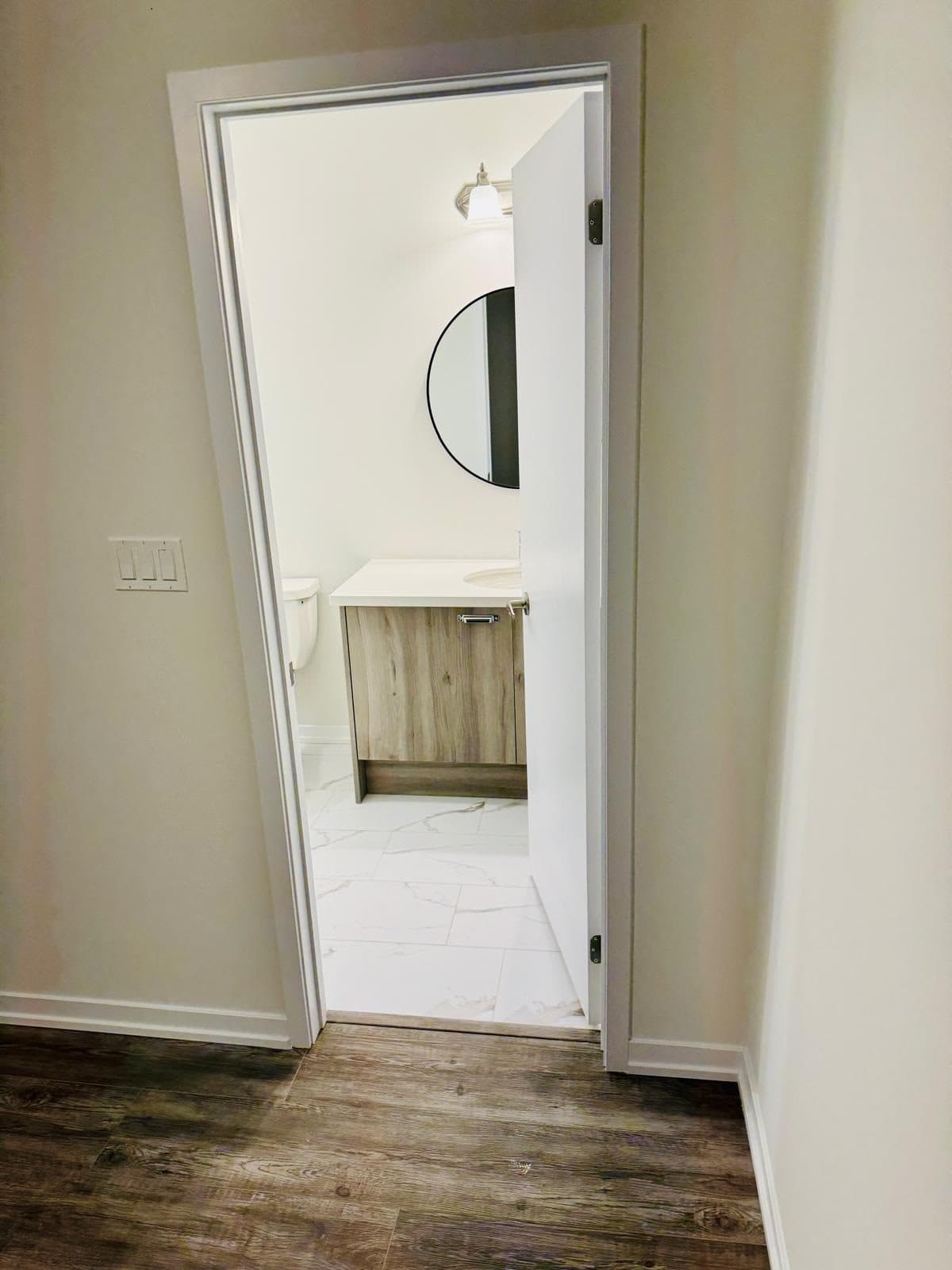 Modern Bathroom with Round Mirror at 1 Bedroom Townhouse in Oshawa for $1,200, a 1 bedroom rental in 2004 Horace Duncan Crescent, Oshawa, ON, listed for $1,200 per month