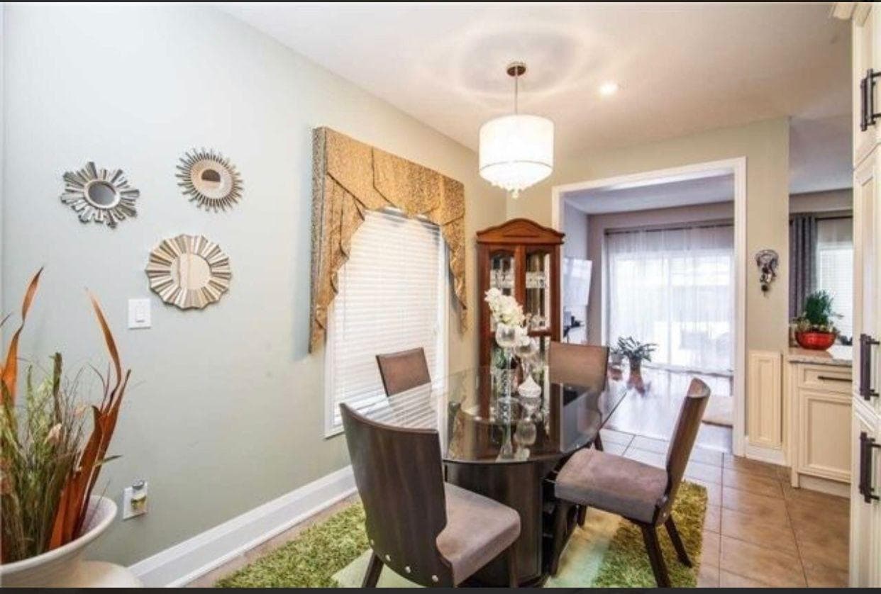 Elegant Dining Area with Glass Table at Spacious 4-Bedroom Detached Home for Rent – 25 Penny Royal Cres, Brampton, a 4 bedroom rental in 25 Pennyroyal Crescent, Brampton, ON, listed for $3,400 per month