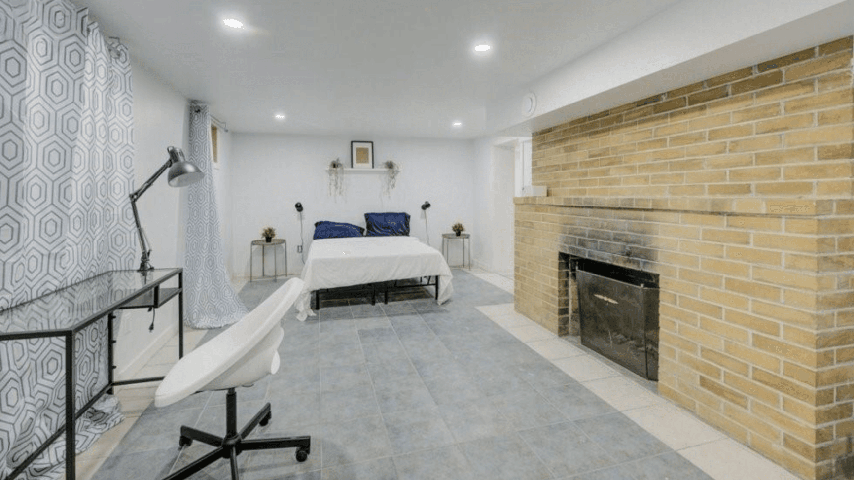 Cozy Bedroom with Desk and Fireplace at Rental Listing in Waterloo, a rental rental in 74 McDougall Road, Waterloo, ON, listed for $6,000 per month