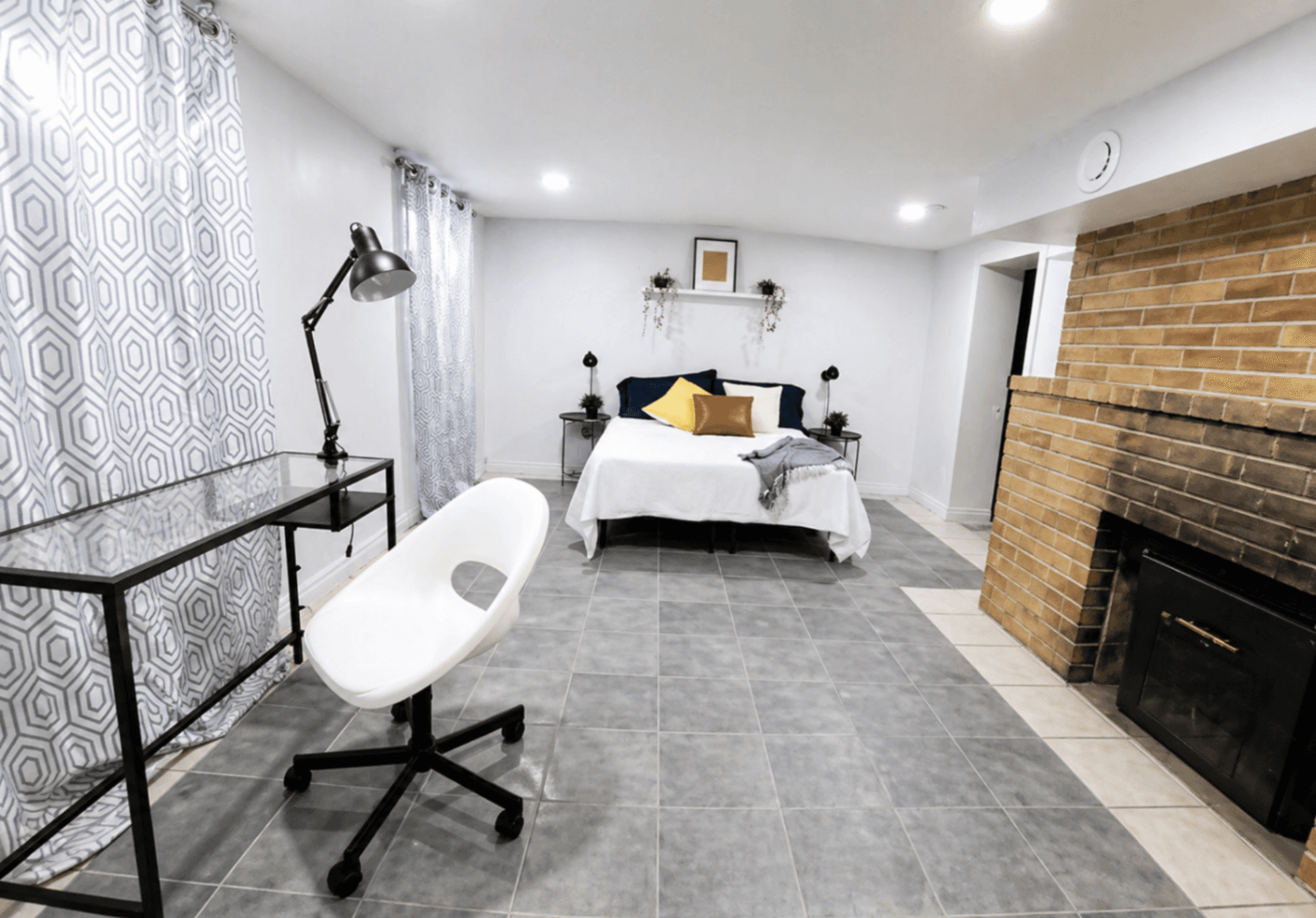 Cozy Bedroom with Desk and Fireplace at 1-Bedroom Basement in Waterloo – Affordable & Private, a rental rental in 74 McDougall Road, Waterloo, ON, listed for $1,200 per month